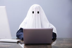 Suited person with ghost sheet on