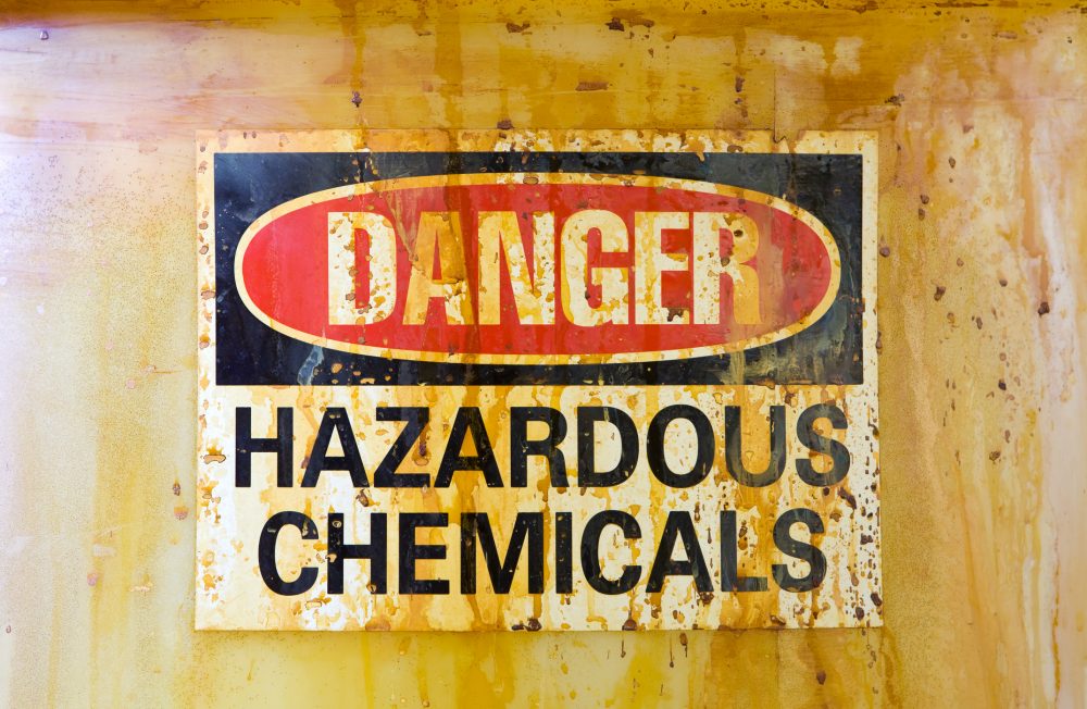 Danger Hazardous Chemicals Sign on a stained storage barrel